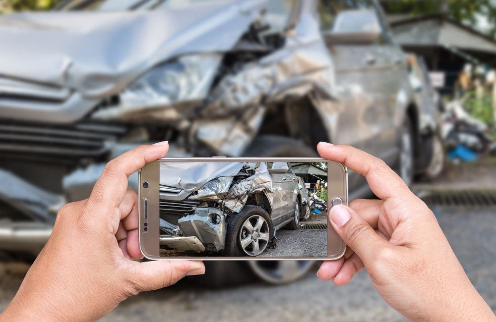 person taking a photo of car accident