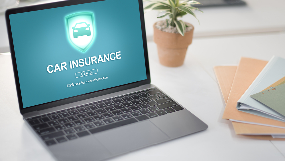 file car insurance claim on laptop