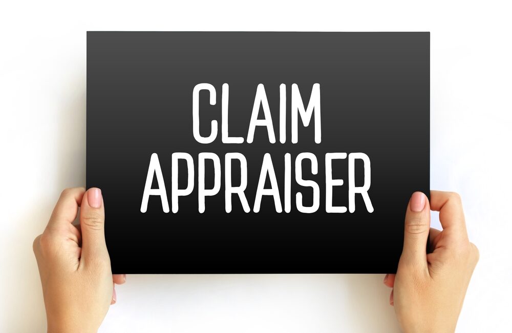 person holding a sign that says claim appraiser