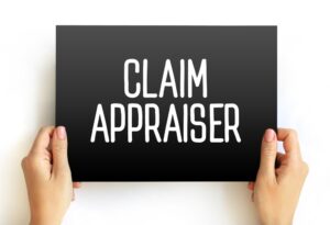 person holding a sign that says claim appraiser