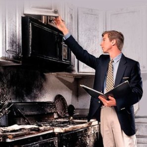 adjuster inspecting a kitchen stove caught on fire