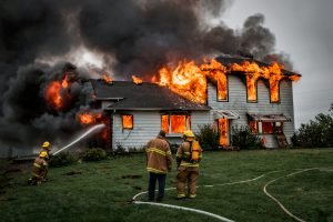 house fire with 3 firefighters putting out the fire