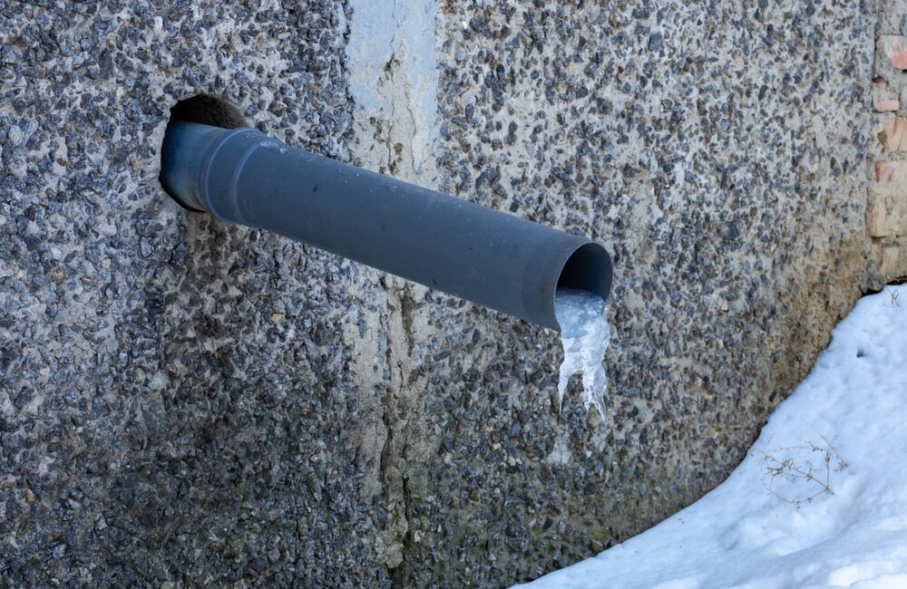 frozen pipe coming out of building