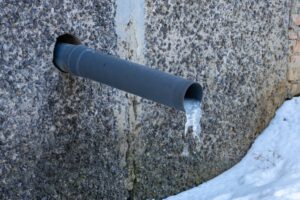 frozen pipe coming out of building